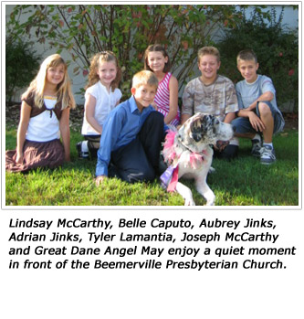 Lindsay McCarthy, Belle Caputo, Aubrey Jinks, Adrian Jinks, Tyler Lamantia, Joseph McCarthy and Great Dane Angel May enjoy a quiet moment in front of the Beemerville Presbyterian Church.  